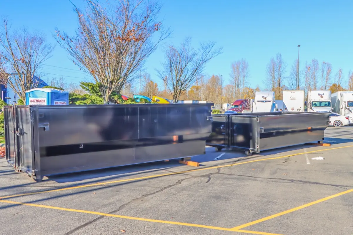 Professional dumpster rental service with roll-off container on residential driveway in Mount Olive